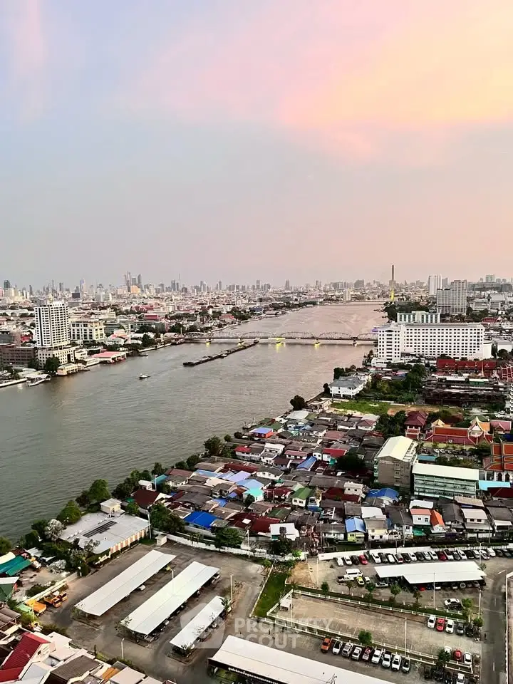 Stunning aerial view of a vibrant cityscape with river and skyline at sunset, perfect for urban living enthusiasts.