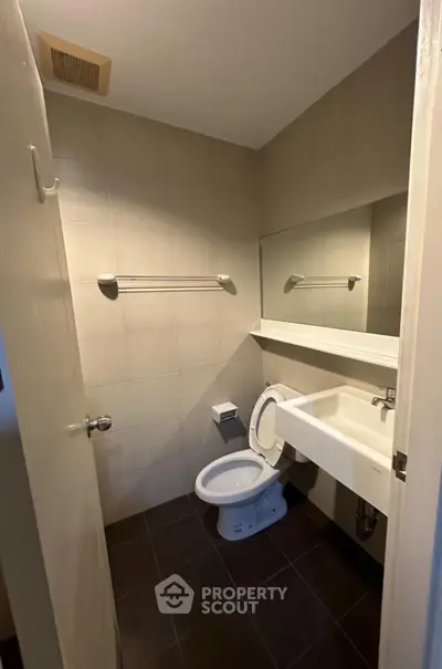 Compact modern bathroom with sleek fixtures and neutral tiles