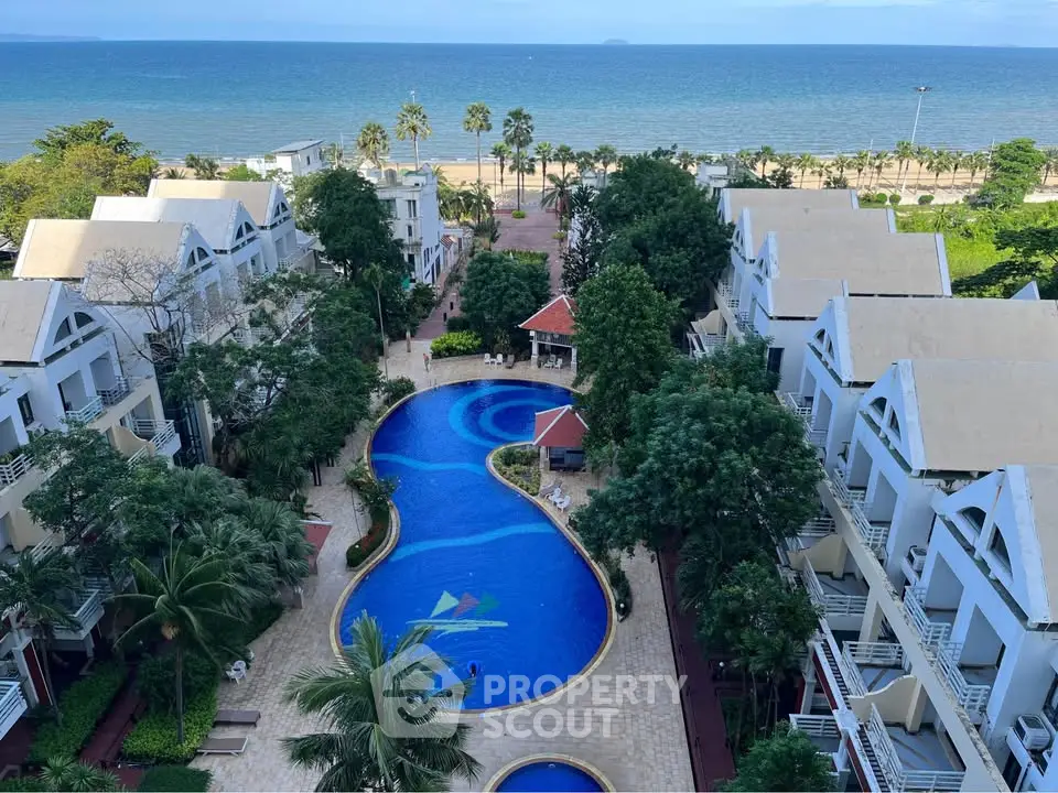 Stunning beachfront property with pool and lush greenery, offering breathtaking ocean views.
