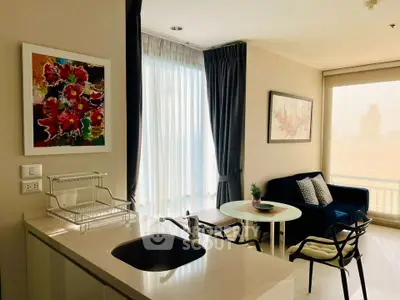 Modern living room with stylish decor and large windows offering natural light.