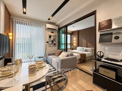 Modern open-plan living room and bedroom with stylish decor and natural light.