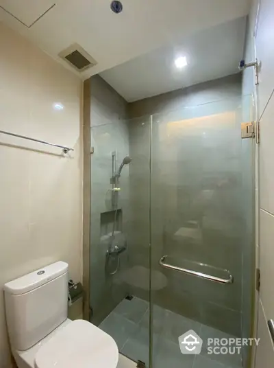 Modern bathroom with glass shower enclosure and sleek fixtures