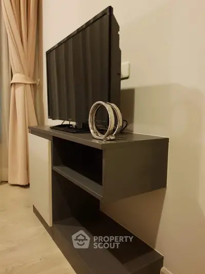 Modern living room with sleek TV stand and elegant decor, perfect for contemporary lifestyle.