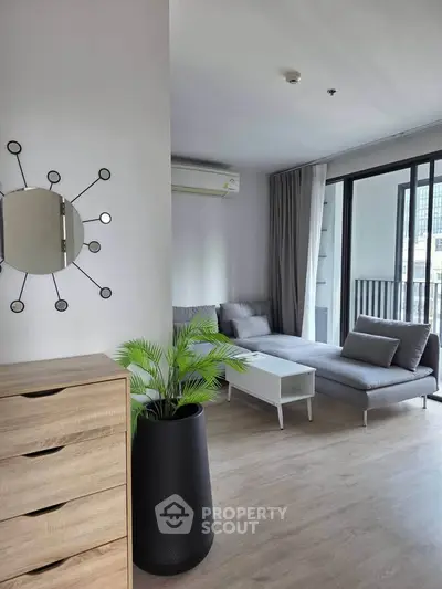 Modern living room with stylish decor and large windows in a contemporary apartment.