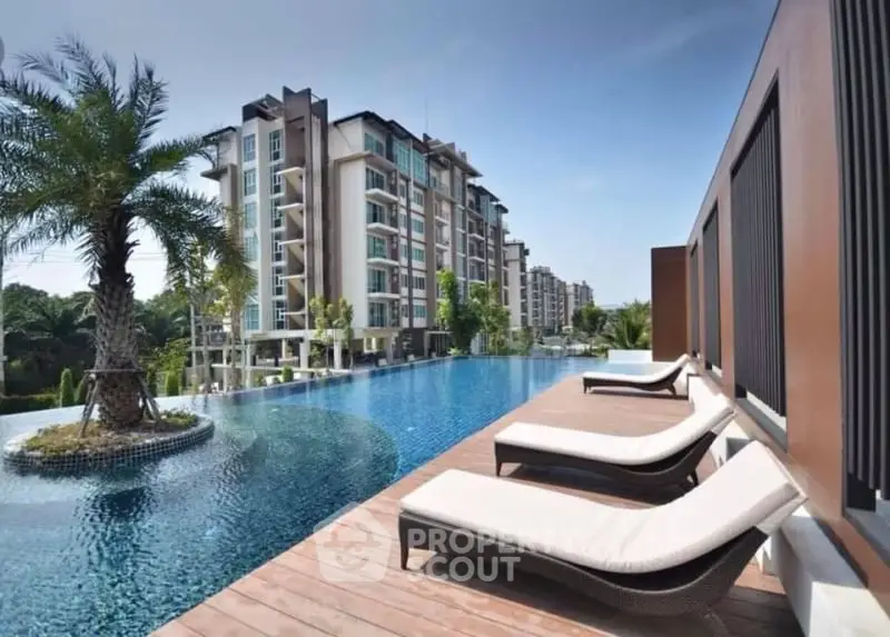 Luxurious apartment complex with stunning poolside view and modern architecture.