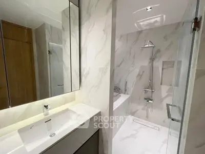 Luxurious modern bathroom with marble walls and sleek fixtures