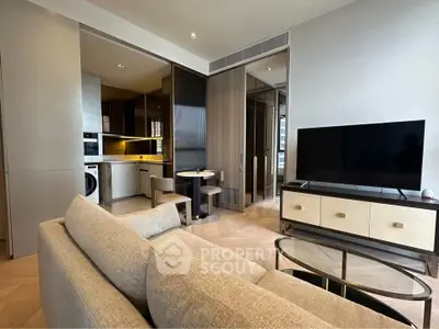 Modern living room with open kitchen, featuring sleek furniture and a large TV, perfect for urban living.