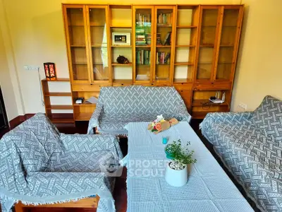 Cozy living room with wooden furniture and decorative plants