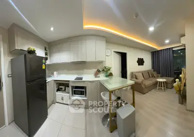 Modern open-layout kitchen and living room with sleek design and ambient lighting
