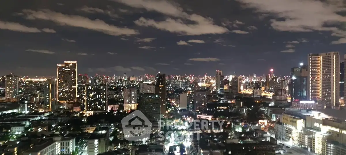 Stunning nighttime cityscape view with illuminated skyline and high-rise buildings.