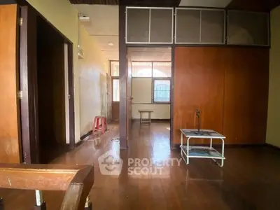 Spacious interior with wooden flooring and natural light, ideal for cozy living.