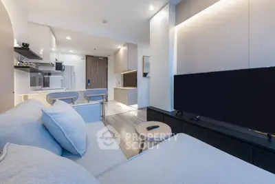 Modern living room with sleek furniture and open kitchen layout, perfect for urban living.