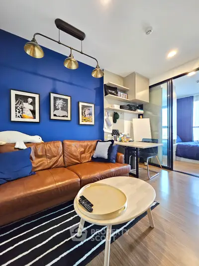 Stylish modern living room with leather sofa, blue accent wall, and cozy decor