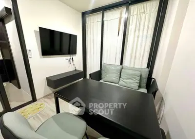 Modern living room with sleek furniture and wall-mounted TV, perfect for cozy gatherings.