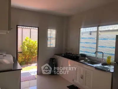 Bright kitchen with open layout and garden access