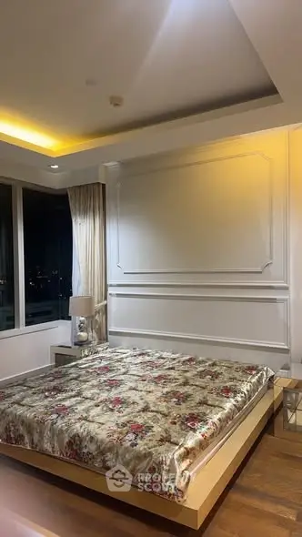 Luxurious bedroom with elegant decor and city view at night