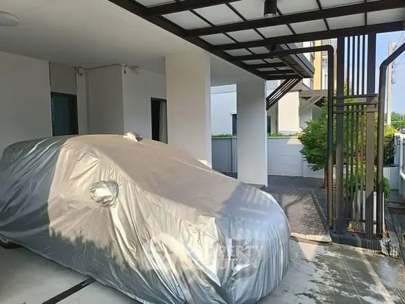 Modern carport with covered vehicle in contemporary residential property