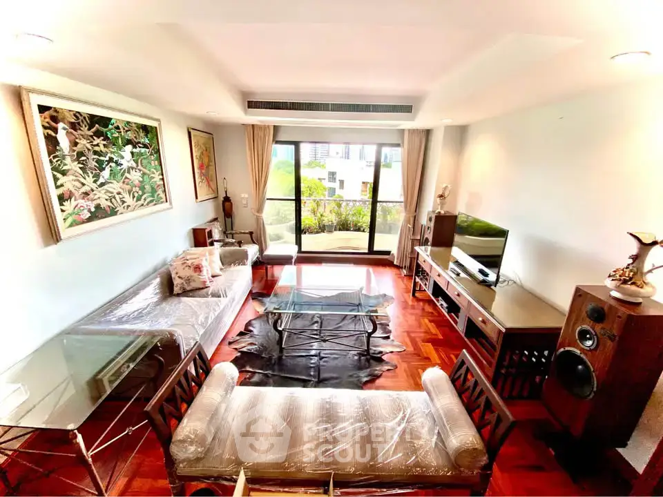 Spacious living room with modern decor and large window view