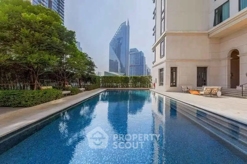 Luxurious apartment building with stunning pool and city skyline view, perfect for urban living.