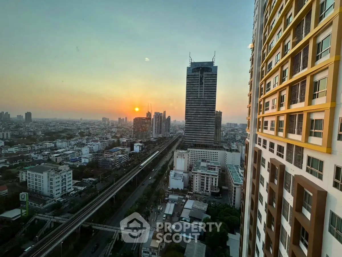 Stunning cityscape view from high-rise building at sunset, showcasing urban skyline and vibrant city life.