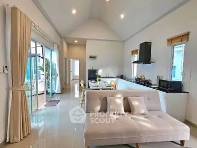 Spacious open-plan living room with modern kitchen and elegant decor