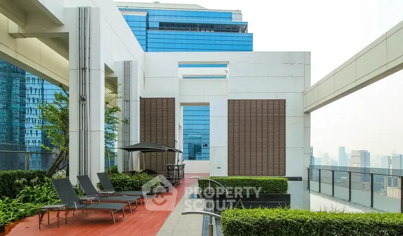 Luxurious rooftop terrace with modern design and stunning city views, perfect for relaxation and entertainment.