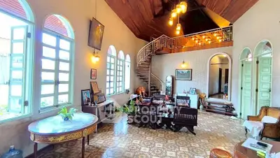 Charming vintage living room with high ceilings and elegant staircase