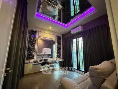 Luxurious living room with modern decor and ambient lighting, featuring a mirrored ceiling and cozy seating.