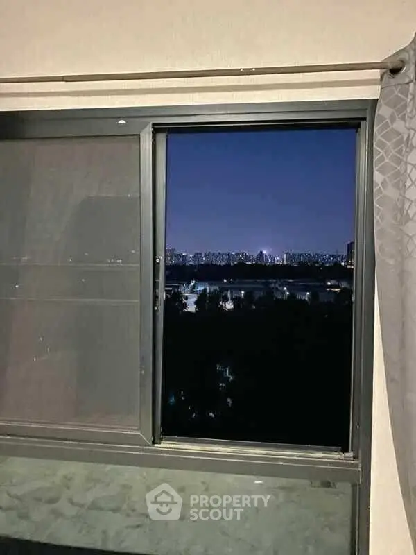 Stunning night cityscape view from a modern apartment window, perfect for urban living enthusiasts.