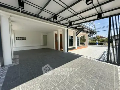 Spacious modern home entrance with covered parking and sleek design