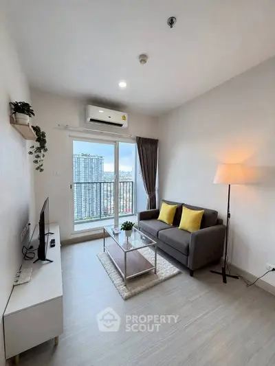 Modern living room with city view, featuring sleek furniture and natural light.