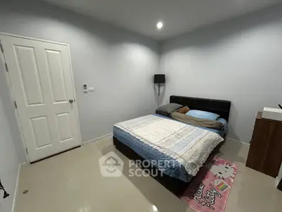 Cozy bedroom with modern decor and comfortable bed in a minimalist style.