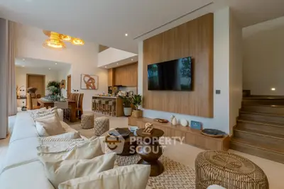 Luxurious open-plan living room with modern decor and wooden accents, perfect for entertaining.