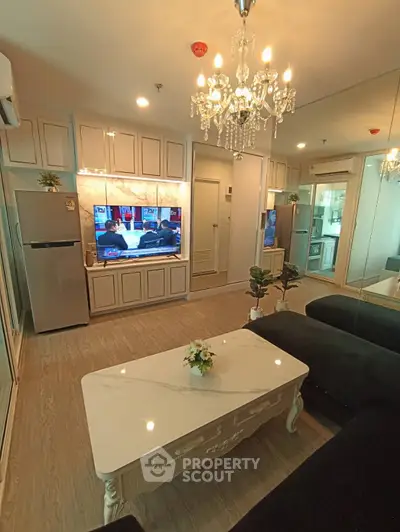 Luxurious living room with elegant chandelier and modern decor in a stylish apartment.