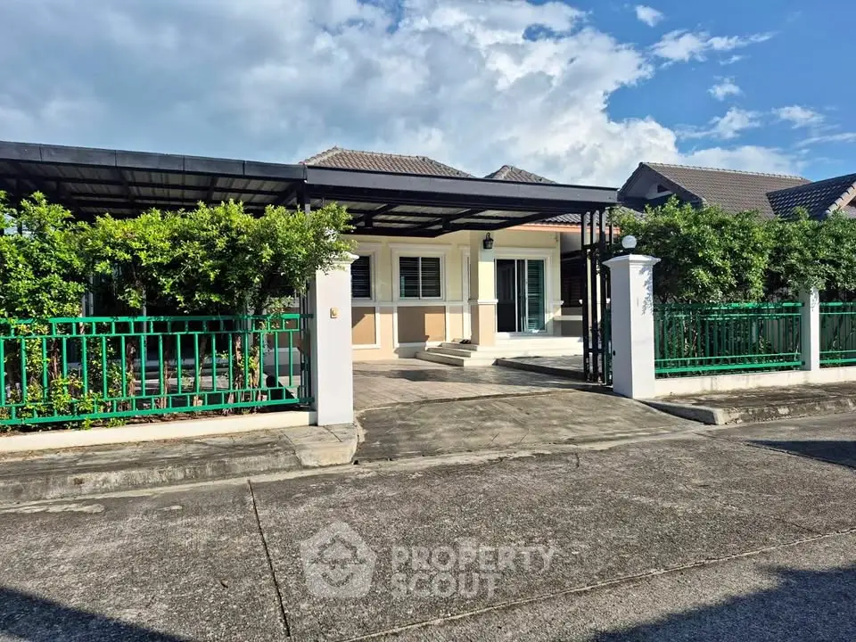 Charming single-story home with lush greenery and spacious driveway in a serene neighborhood.