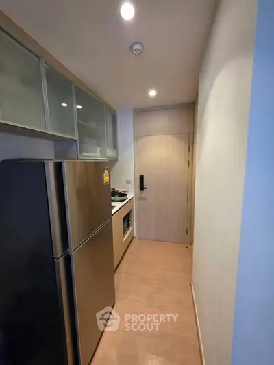 Modern compact kitchen with sleek appliances and closed layout design