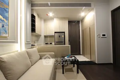 Modern open-plan kitchen and living room with sleek design and neutral tones.