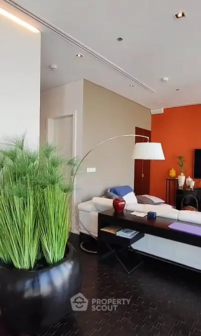 Stylish modern living room with vibrant decor and elegant lighting