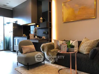Modern living room with stylish decor and open kitchen layout, featuring cozy seating and elegant lighting.