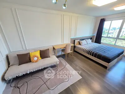 Spacious modern bedroom with stylish decor and large window view