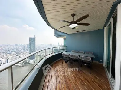 Stunning high-rise balcony with panoramic city and river views, perfect for outdoor dining and relaxation.