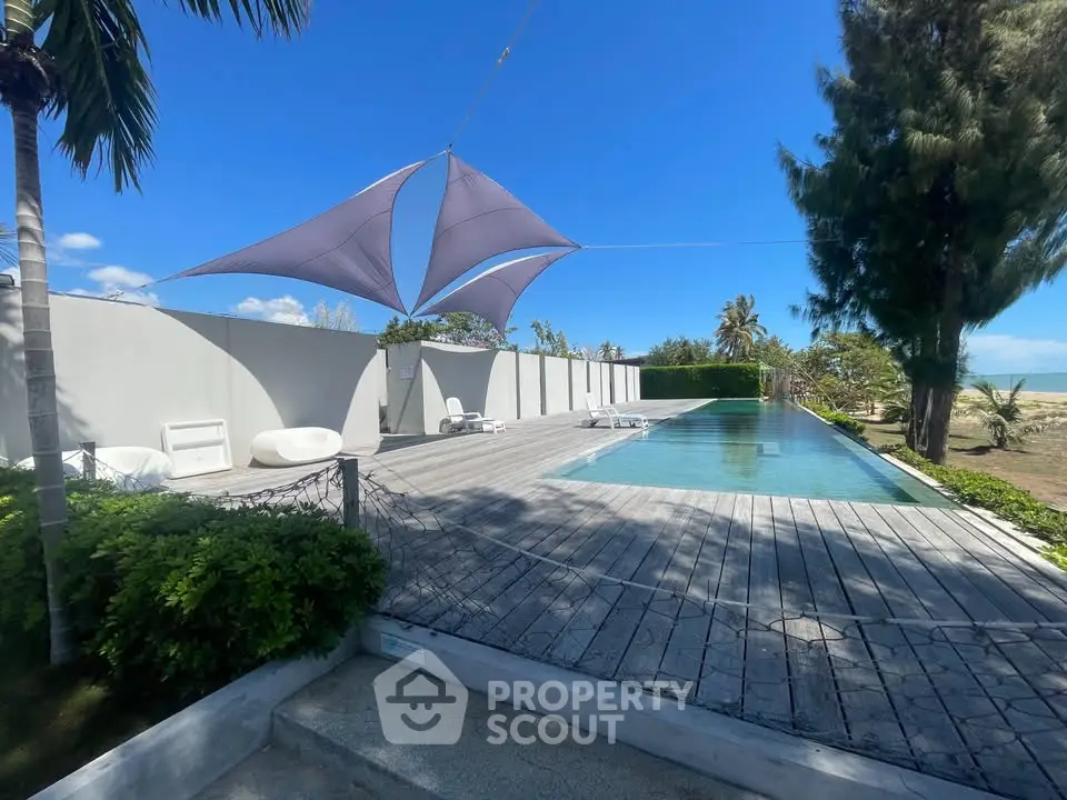 Luxurious beachfront pool with modern design and stunning ocean view