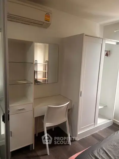 Cozy bedroom with modern furniture and air conditioning, perfect for comfortable living.