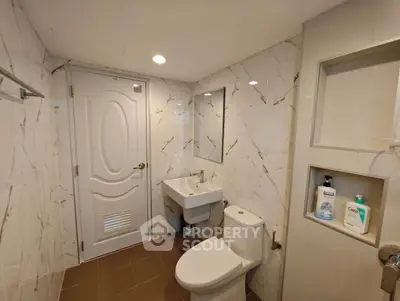 Modern bathroom with elegant marble walls and sleek fixtures