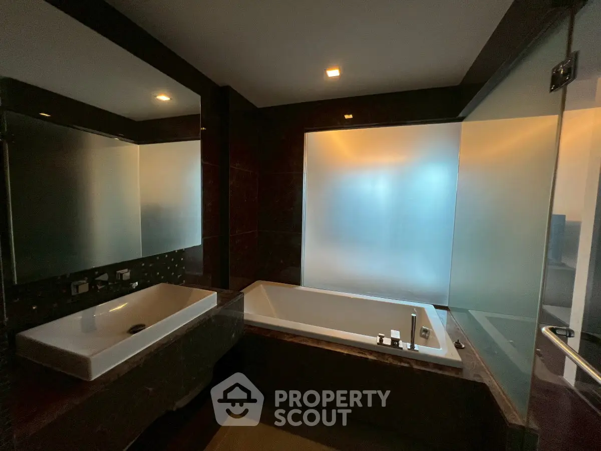 Luxurious bathroom with modern fixtures and frosted glass window
