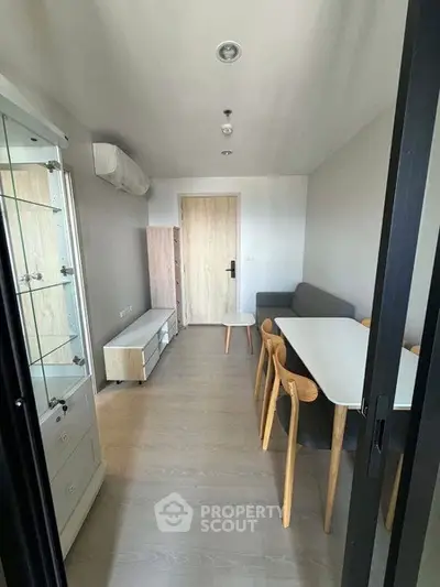Modern dining area with sleek furniture and minimalist design in a bright apartment.