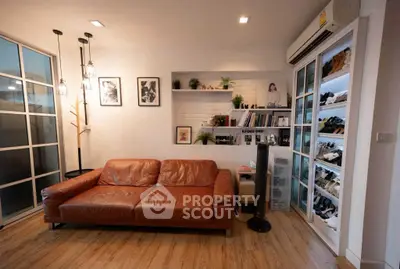 Stylish living room with leather sofa, modern decor, and ample shoe storage