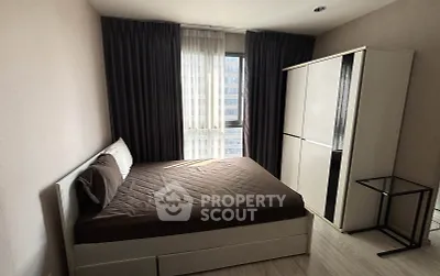 Modern bedroom with large window and sleek wardrobe in urban apartment