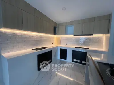Modern kitchen with sleek cabinetry and under-cabinet lighting