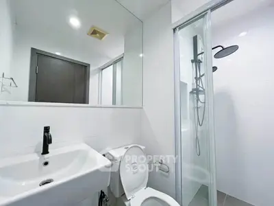 Modern bathroom with sleek fixtures and glass shower enclosure